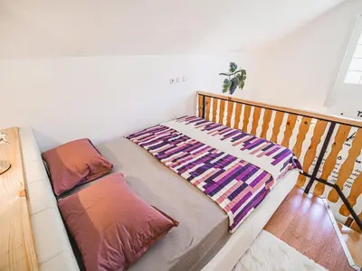 a bedroom with a bed and a railing at Harvest Horizon Holiday Home with Sauna - One Bedroom Holiday Home in Brežice