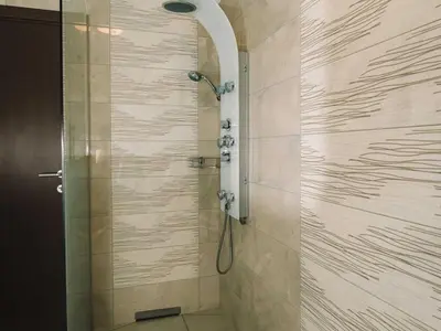 a shower with a glass door in a bathroom at Bled Prestigious and Stylish Apartments - Classic Studio Apartment with Terrace in Bled