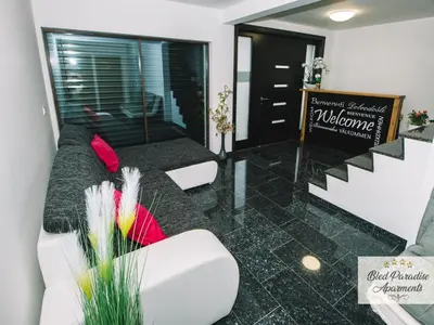 a living room with a couch and chairs and a sign at Bled Prestigious and Stylish Apartments - Classic Studio Apartment with Terrace in Bled
