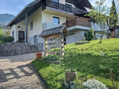 a house with a garden in front of it at Two Bedroom Apartment with Balcony and Mountain View in Preddvor