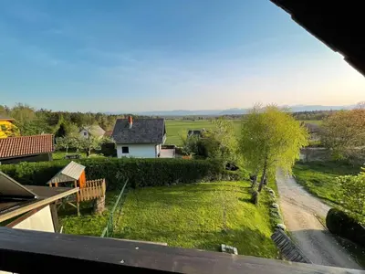 a view of a garden from the balcony of a house at Two Bedroom Apartment with Balcony and Mountain View in Preddvor