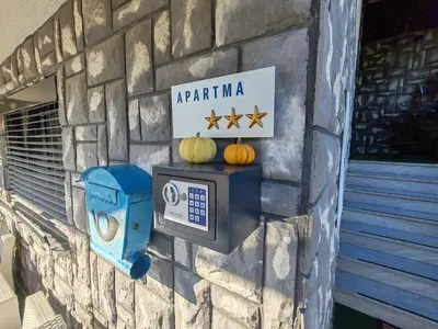 a stone wall with a meter and pumpkins on it at Brezovica Spacious Family-Friendy Apartment - Two Bedroom Apartment with Balcony in Smarjeske Toplice
