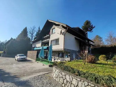 a house with a car parked in front of it at Brezovica Spacious Family-Friendy Apartment - Two Bedroom Apartment with Balcony in Smarjeske Toplice