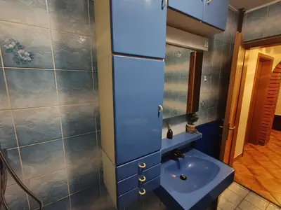 a bathroom with a blue sink and a mirror at Brezovica Spacious Family-Friendy Apartment - Two Bedroom Apartment with Balcony in Smarjeske Toplice