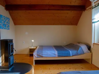 a bedroom with a bed and a tv in a room at Hillside Haven Holiday Home with Sauna and Hot-Tub - One Bedroom Holiday Home with Sauna and Hot-Tub in Podbočje