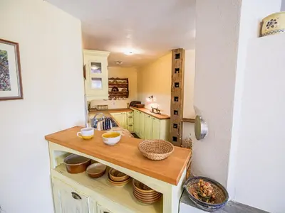 a kitchen with a counter with bowls and plates on it at Hidden Authentic Haven Apartments - One Bedroom Apartment with Terrace in Sevnica