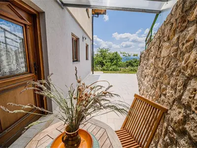a vase sitting on a table next to a door at Hidden Authentic Haven Apartments - One Bedroom Apartment with Terrace in Sevnica
