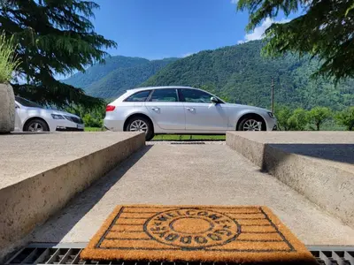 a car is parked next to a grate in the road at Peaceful Countryside Holiday Home with Terrace - One Bedroom Holiday Home with Terrace in Tolmin