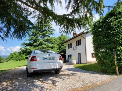 a silver car parked in front of a house at Peaceful Countryside Holiday Home with Terrace - One Bedroom Holiday Home with Terrace in Tolmin