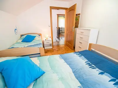 a bedroom with two beds and a dresser in it at Sunny and Comfortable Apartment with Terrace and Garden - Two Bedroom Apartment with Terrace in Rečica ob Savinji