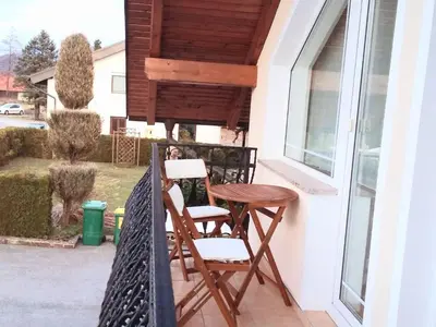a pair of chairs and a table on a porch at Sunny and Comfortable Apartment with Terrace and Garden - Two Bedroom Apartment with Terrace in Rečica ob Savinji