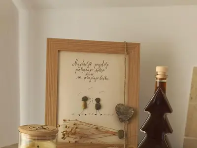 a picture in a wooden frame with a bottle of wine at Sunny and Comfortable Apartment with Terrace and Garden - Two Bedroom Apartment with Terrace in Rečica ob Savinji