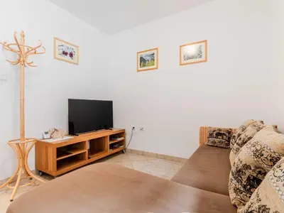 a living room with a couch and a flat screen tv at Log pod Mangartom Amazing Apartment with Balcony - One Bedroom Apartment with Balcony in Log pod Mangartom
