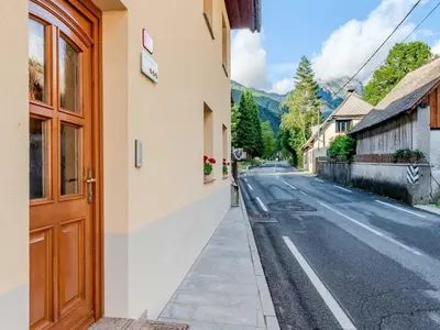 a building with a door on the side of a street at Log pod Mangartom Amazing Apartment with Balcony - One Bedroom Apartment with Balcony in Log pod Mangartom