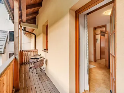 a balcony with a table and a bench on it at Log pod Mangartom Amazing Apartment with Balcony - One Bedroom Apartment with Balcony in Log pod Mangartom