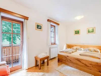 a bedroom with a bed and a large window at Log pod Mangartom Amazing Apartment with Balcony - One Bedroom Apartment with Balcony in Log pod Mangartom