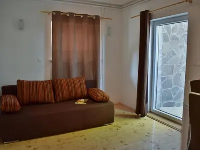 a living room with a couch and a window at Standard One Bedroom Apartment in Brežice