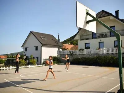 a group of people playing basketball on a court at Standard One Bedroom Apartment in Brežice