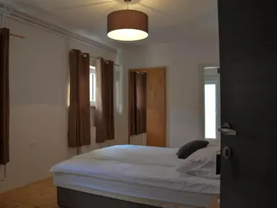 a bedroom with a bed with a light on the ceiling at Standard One Bedroom Apartment in Brežice