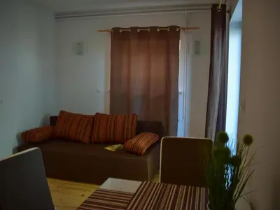 a living room with a couch and a table at Standard One Bedroom Apartment in Brežice