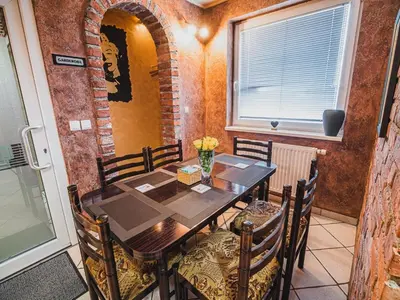 a dining room with a wooden table and chairs at Elegant and Stylish Retreat Apartments with Terrace - Two Bedroom Apartment with Terrace in Brežice