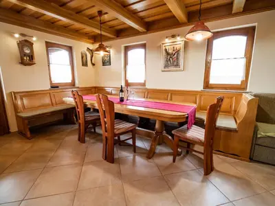 a dining room with a wooden table and chairs at Vivid Hillside Country House with Hot-Tub and Sauna - Two Bedroom Country House in Sevnica
