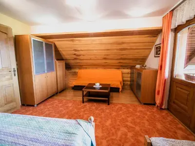a bedroom with a bed and a table in a room at Vivid Hillside Country House with Hot-Tub and Sauna - Two Bedroom Country House in Sevnica