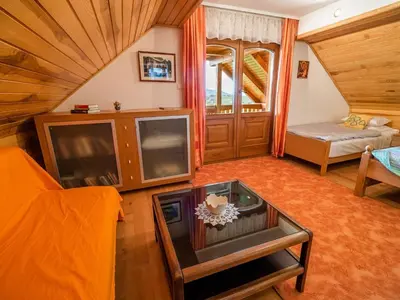 a living room with a tv and a couch at Vivid Hillside Country House with Hot-Tub and Sauna - Two Bedroom Country House in Sevnica