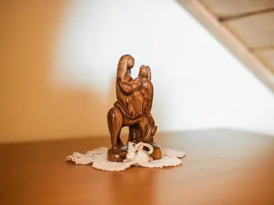 a small figurine of a man sitting on a table at Vivid Hillside Country House with Hot-Tub and Sauna - Two Bedroom Country House in Sevnica