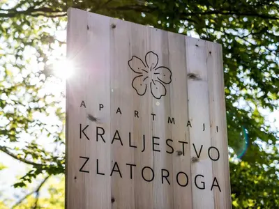 a wooden sign with a clover painted on it at The Woodland Nook Apartments Bohinj - Standard Two Bedroom Apartment with Balcony in Bohinj