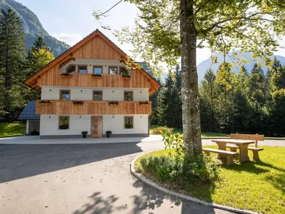 a building with a picnic table in front of it at The Woodland Nook Apartments Bohinj - Standard Two Bedroom Apartment with Balcony in Bohinj