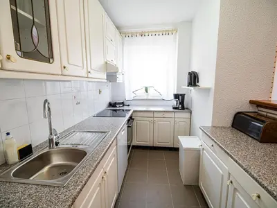 a kitchen with white cabinets and a sink at Mountain View Haven Apartments - Two Bedroom Apartment with Balcony in Bovec