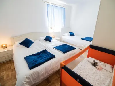 a bedroom with two beds with blue pillows at Mountain View Haven Apartments - Two Bedroom Apartment with Balcony in Bovec