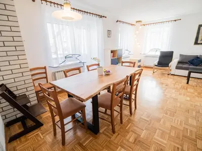 a living room with a wooden table and chairs at Mountain View Haven Apartments - Two Bedroom Apartment with Balcony in Bovec