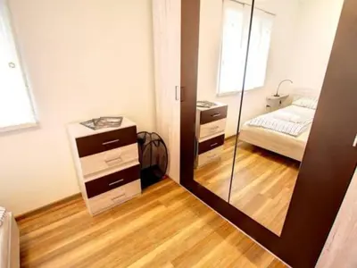 a bedroom with a mirror and a bed in it at Stylish Retreat with BBQ and Modern Amenities near Terme - Three Bedroom Apartment in Dobova