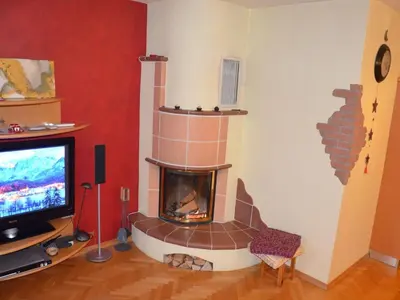 a living room with a fireplace and a tv at Two Bedroom Apartment with Balcony in Kranjska Gora