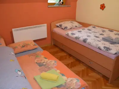 a bedroom with two beds and two tables with towels at Two Bedroom Apartment with Balcony in Kranjska Gora