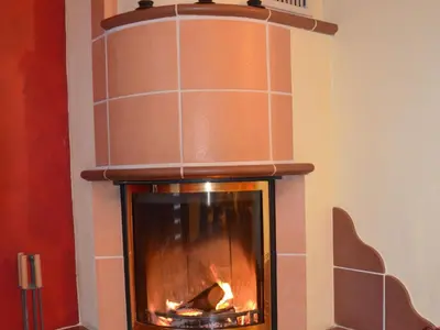a fireplace in a room with a fire at Two Bedroom Apartment with Balcony in Kranjska Gora