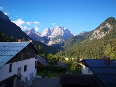 a view of the mountains from a house at Two Bedroom Apartment with Balcony in Kranjska Gora