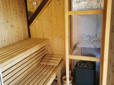 a sauna with a bench and a sink in it at Mountain Vista Cottage with Private Sauna - One Bedroom Cottage in Škofja Loka