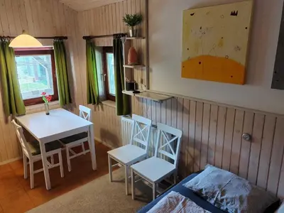 a room with a table and two chairs and a table and a table at Mountain Vista Cottage with Private Sauna - One Bedroom Cottage in Škofja Loka