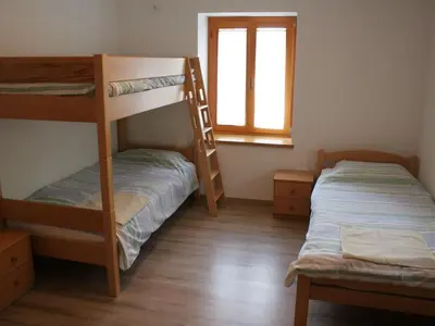 a bedroom with two bunk beds and a window at Riverside Rustic Ridge Apartments with Balcony - Three Bedroom Apartment with Balcony in Slappe dʼIdria