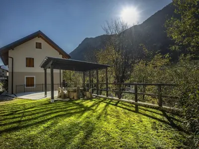 a house with a fence and a grass yard at Riverside Rustic Ridge Apartments with Balcony - Three Bedroom Apartment with Balcony in Slappe dʼIdria