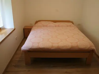 a small bed in a small room with a bed sidx sidx sidx at Riverside Rustic Ridge Apartments with Balcony - Three Bedroom Apartment with Balcony in Slappe dʼIdria