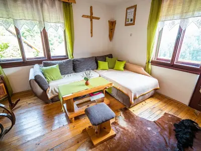 a living room with a couch and a table at Bloomfield Retreat Country House with Sauna - Three Bedroom Country House in Rečica ob Savinji