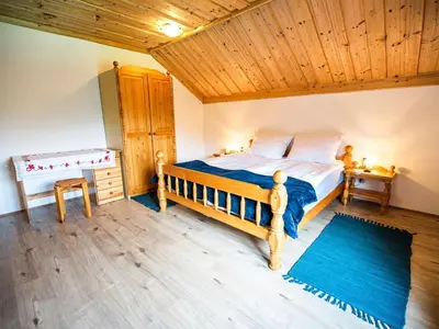 a bedroom with a bed and a wooden ceiling at Bloomfield Retreat Country House with Sauna - Three Bedroom Country House in Rečica ob Savinji