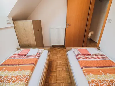 two beds in a small room with at Bovec Picturesque Mountain Vista Residences - Two Bedroom Apartment in Bovec