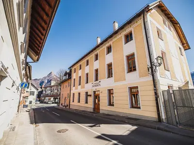 a street with a building on the side of the road at Bovec Picturesque Mountain Vista Residences - Two Bedroom Apartment in Bovec