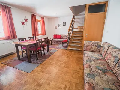 a living room with a couch and a table at Bovec Picturesque Mountain Vista Residences - Two Bedroom Apartment in Bovec