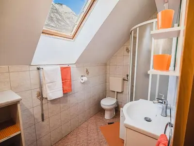 a bathroom with a toilet and a sink at Bovec Picturesque Mountain Vista Residences - Two Bedroom Apartment in Bovec